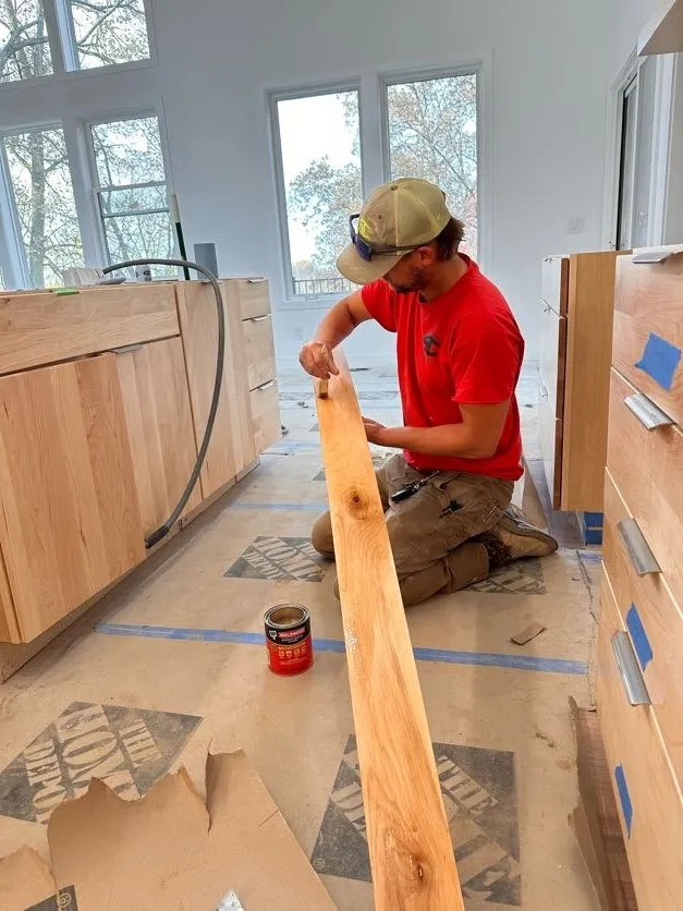 Scheidel Construction carpenter fitting interior finish carpentry on a new construction in West Michigan